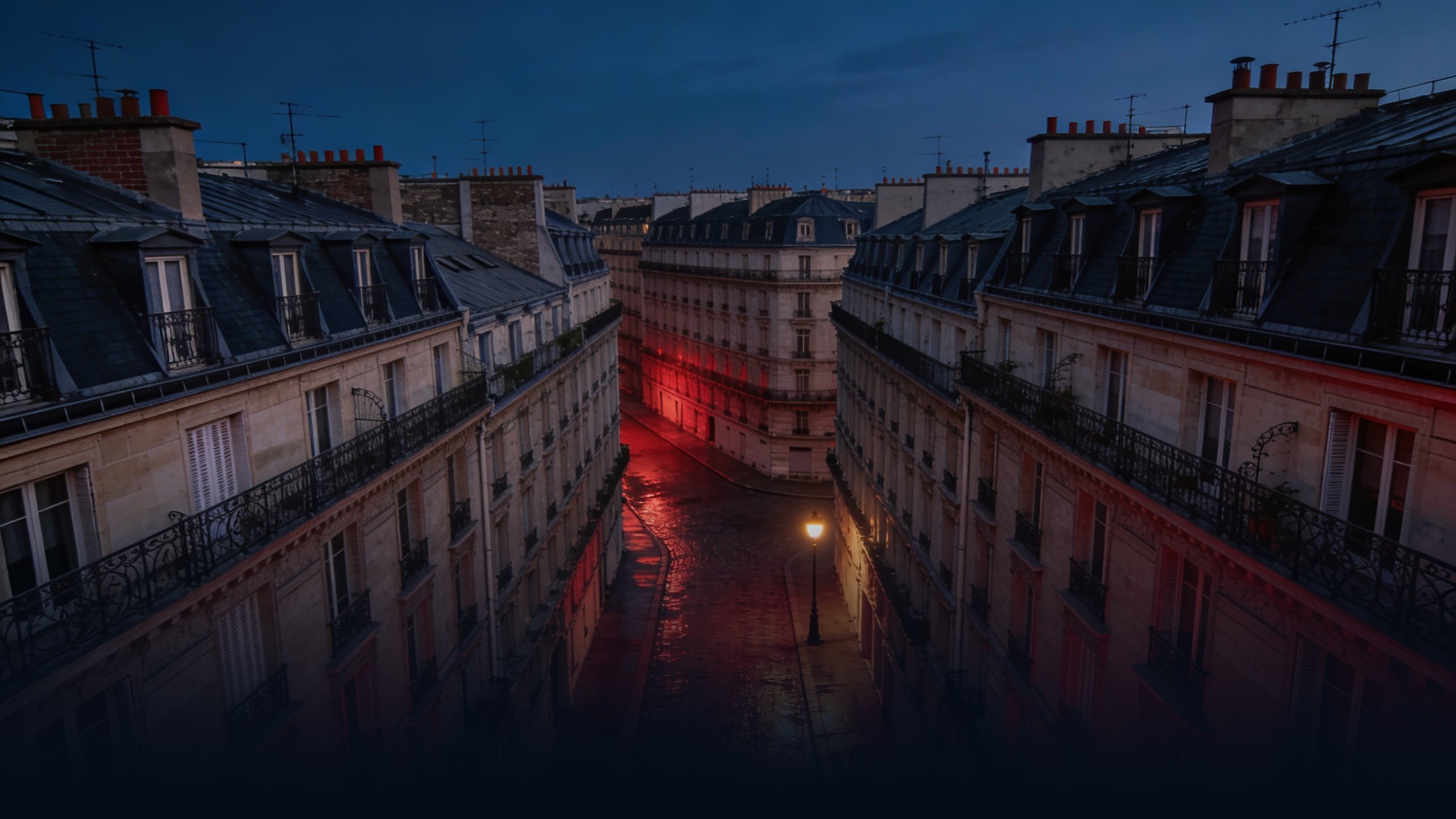 Aerial view down a quiet Paris cobblestone street at twilight from above, classic Haussmann limestone buildings lining both sides with wrought-iron balconies and slate mansard roofs