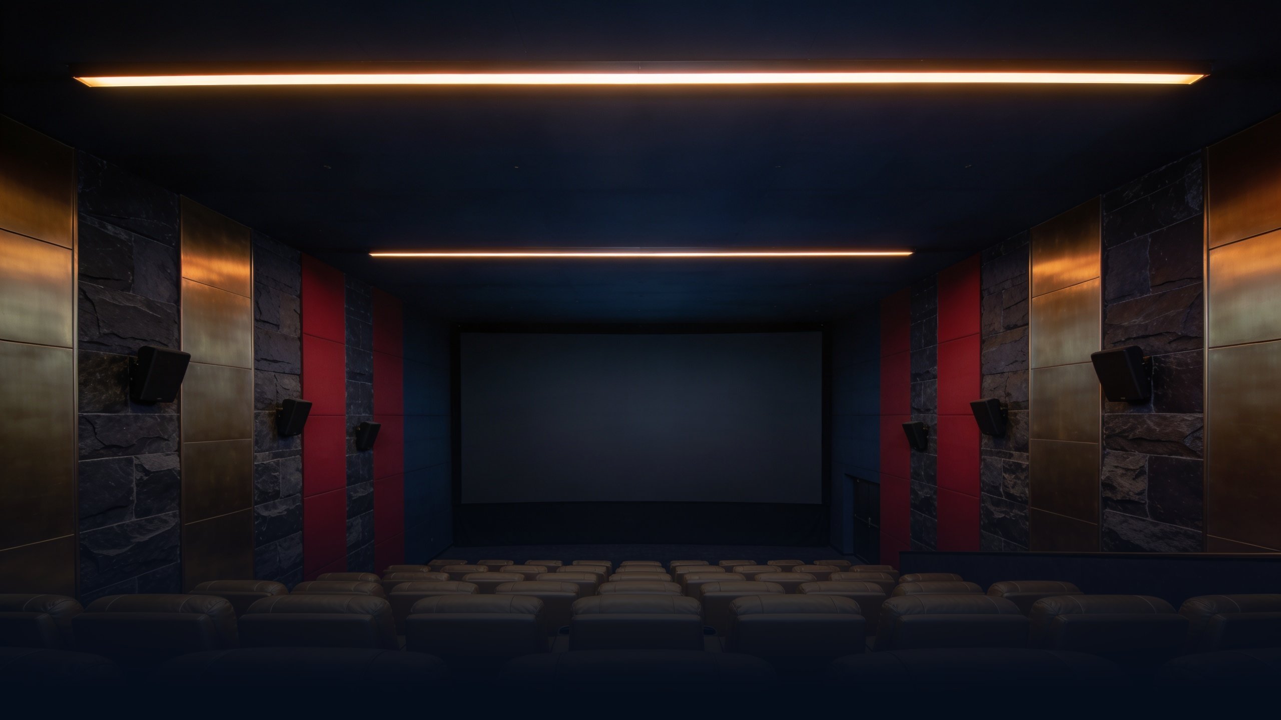 Empty modern Dubai luxury cinema interior at dusk with sleek minimalist auditorium, rows of empty large reclining seats in pale gold leather, single overhead linear LED strip providing warm amber ambient light, brushed brass and dark stone accents